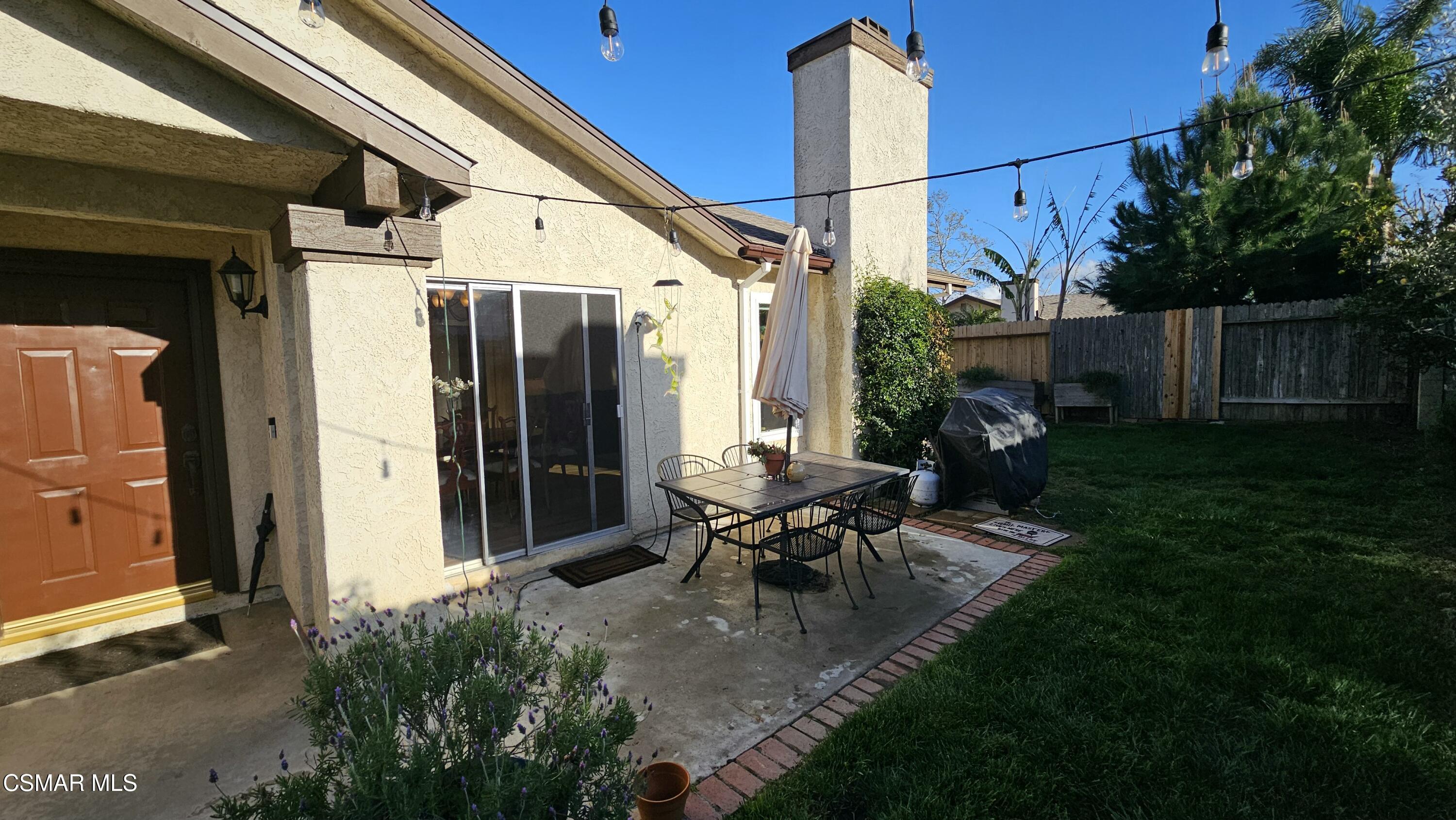14640 Marymount Street Moorpark, CA 93021 - Photo 3 of 33 a view of a patio with table and chairs and potted plants