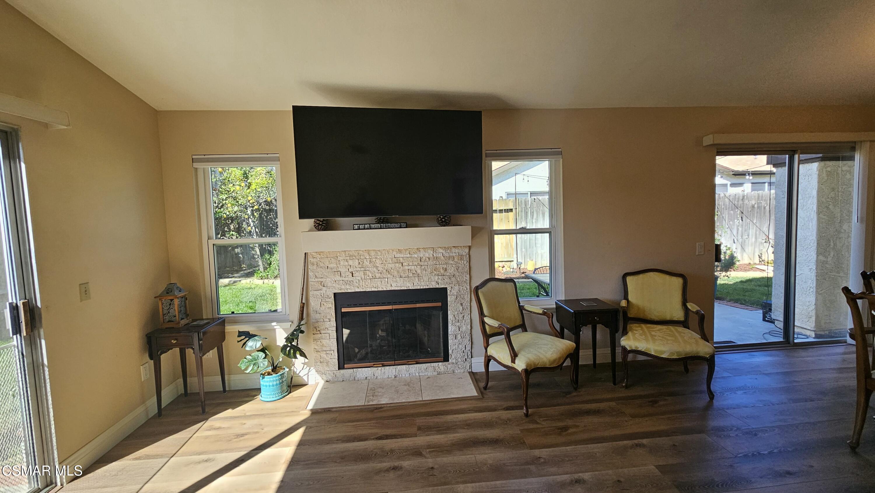 14640 Marymount Street Moorpark, CA 93021 - Photo 6 of 33 a living room with furniture a flat screen tv and a fireplace