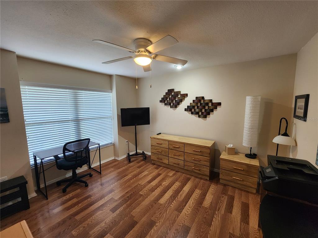 948 North Beneva Road, Unit V25 Sarasota, FL 34232 - Photo 18 of 29 a bedroom with a bed and a chandelier
