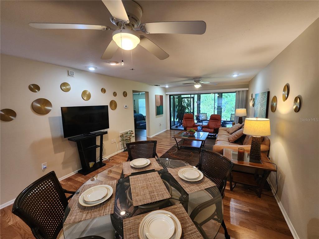 948 North Beneva Road, Unit V25 Sarasota, FL 34232 - Photo 2 of 29 a living room with furniture kitchen view and a flat screen tv
