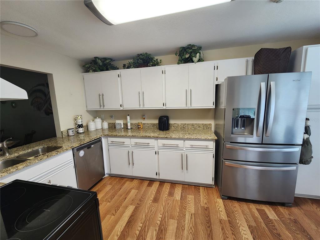 948 North Beneva Road, Unit V25 Sarasota, FL 34232 - Photo 22 of 29 a kitchen with granite countertop a refrigerator stove top oven and sink