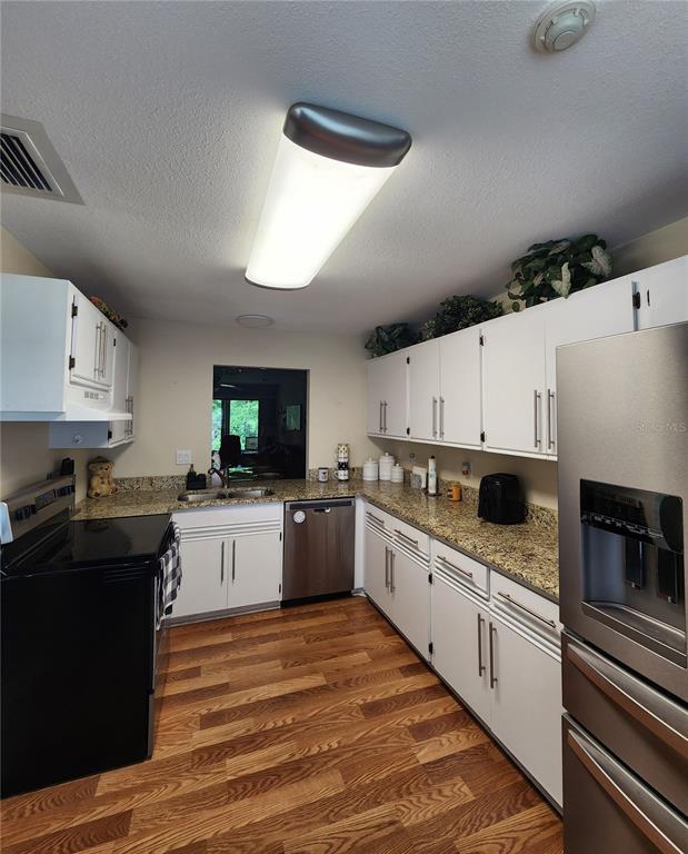 948 North Beneva Road, Unit V25 Sarasota, FL 34232 - Photo 23 of 29 a kitchen with a sink stove and microwave