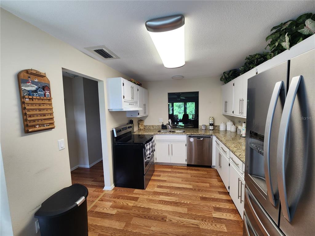 948 North Beneva Road, Unit V25 Sarasota, FL 34232 - Photo 24 of 29 a kitchen with a refrigerator and a sink