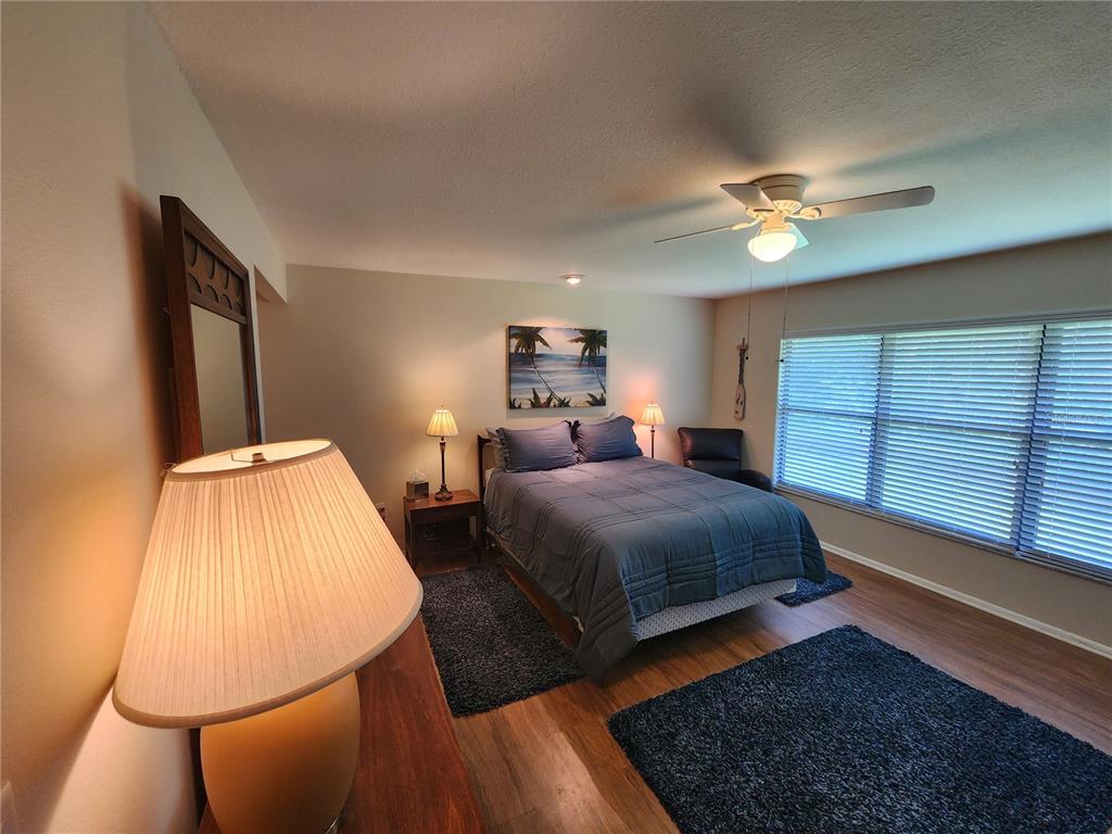 948 North Beneva Road, Unit V25 Sarasota, FL 34232 - Photo 3 of 29 a bedroom with a large bed and a chandelier