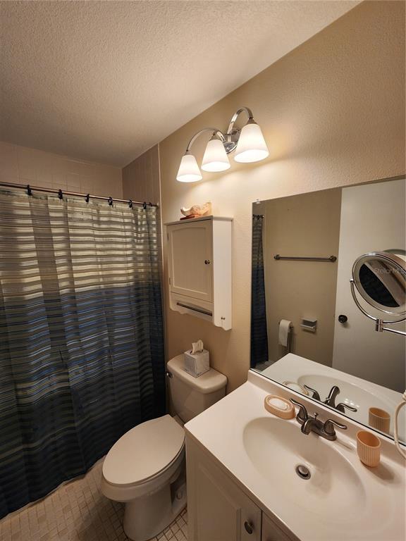 948 North Beneva Road, Unit V25 Sarasota, FL 34232 - Photo 6 of 29 a bathroom with a sink a toilet and mirror