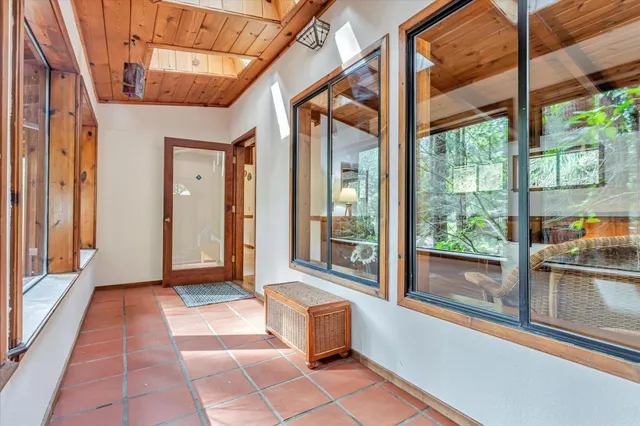a view of a balcony with wooden floor and fence