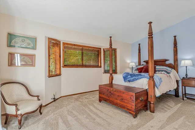 a bedroom with a bed and a large window