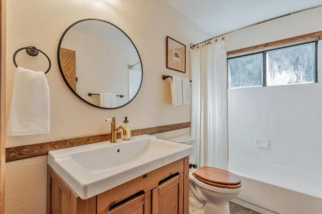 a living room with furniture a window and a chandelier