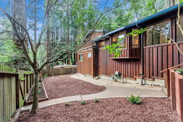 a view of a backyard of a house with table and chairs