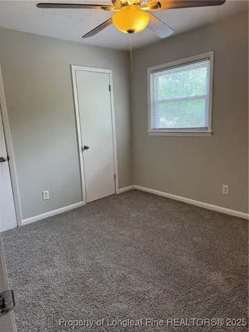 an empty room with a window and closet