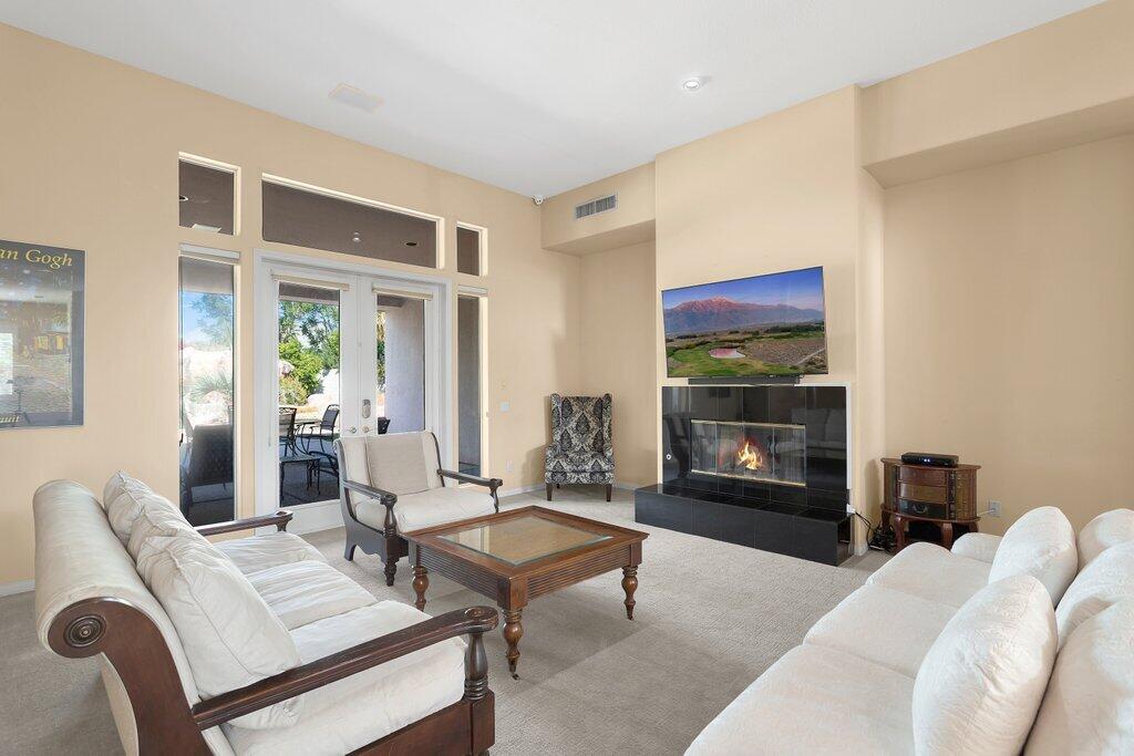 8 MacBeth Court Rancho Mirage, CA 92270 - Photo 6 of 46 a living room with furniture and a fireplace
