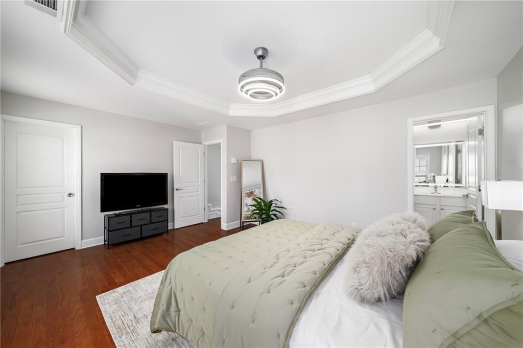 2872 Overlook Way Northeast Atlanta, GA 30324 - Photo 27 of 47 a bedroom with a bed and a flat tv screen on dresser