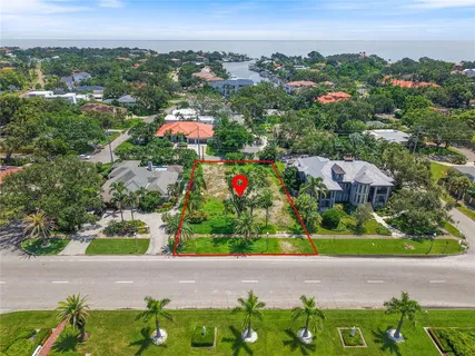 an aerial view of residential houses with outdoor space and trees