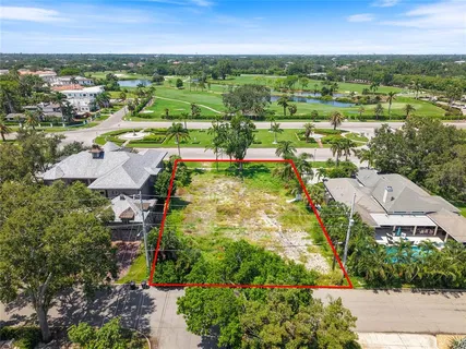 an aerial view of residential houses with outdoor space and street view
