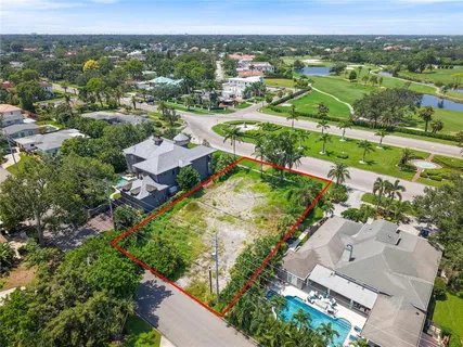an aerial view of residential houses with outdoor space and river
