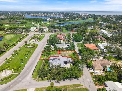 an aerial view of residential houses with outdoor space and street view