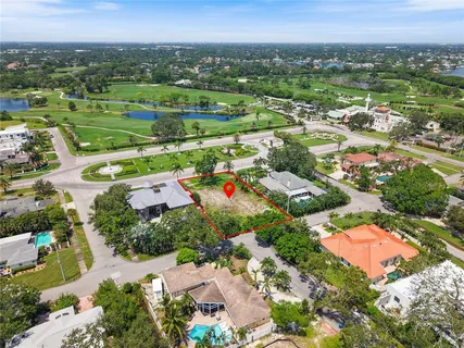 an aerial view of residential houses with outdoor space and swimming pool