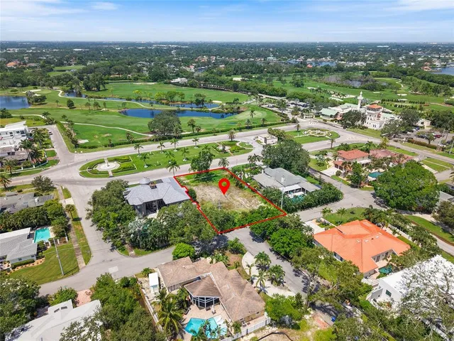 an aerial view of residential houses with outdoor space and swimming pool