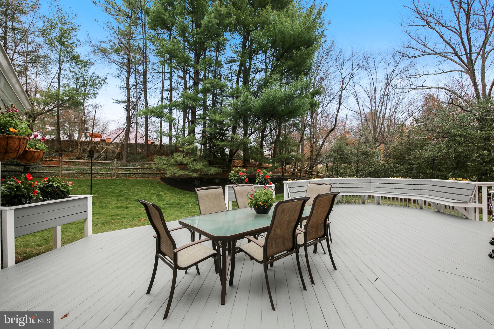 8801 Cold Spring Road Potomac, MD 20854 - Photo 16 of 44 a table and chairs with potted plants on wooden floor