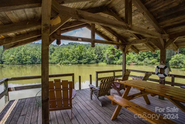 a view of a balcony with chairs and wooden floor