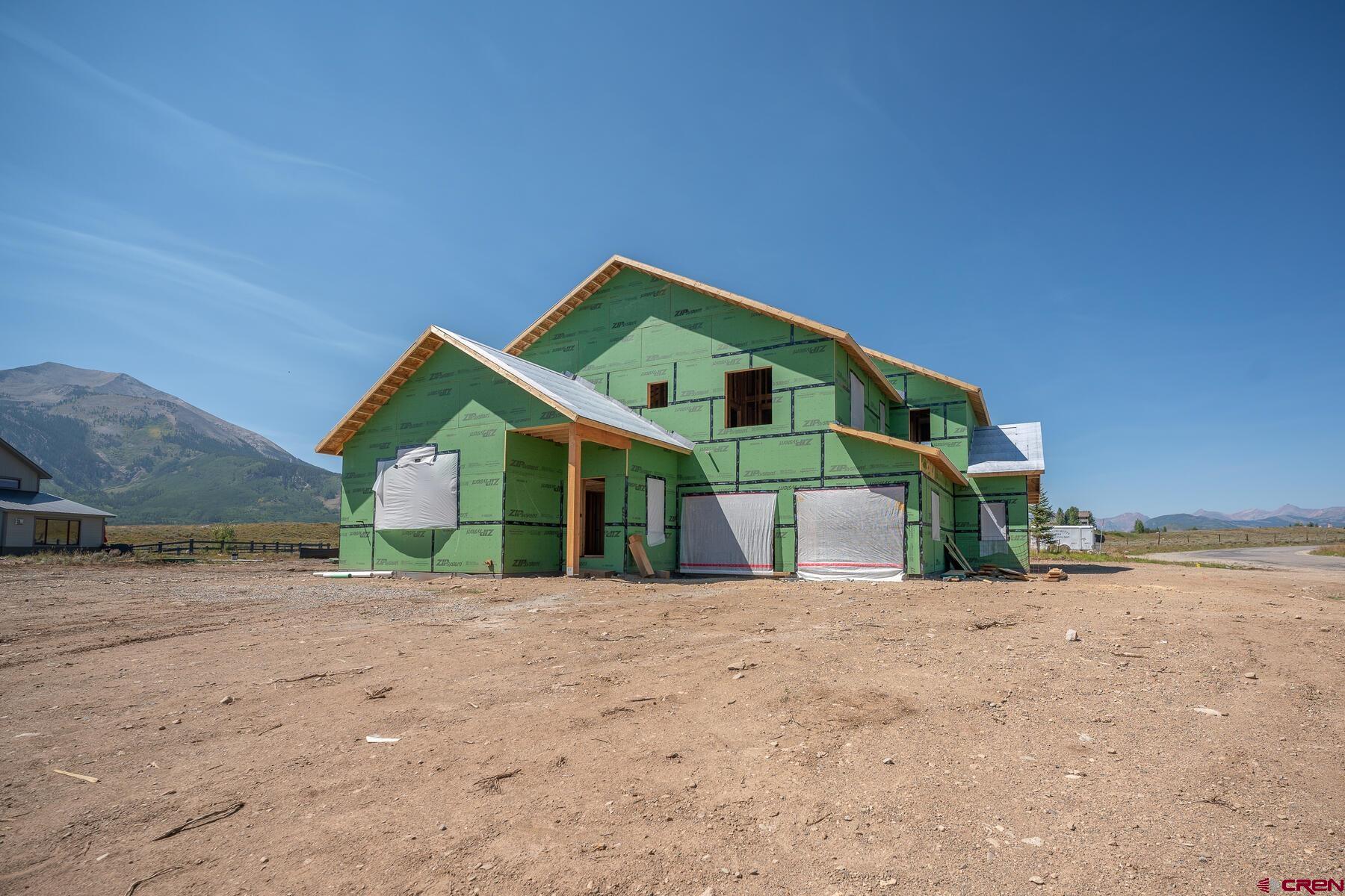 34 Elk Valley Road Crested Butte, CO 81224 - Photo 12 of 24 a front view of a house with a yard and garage
