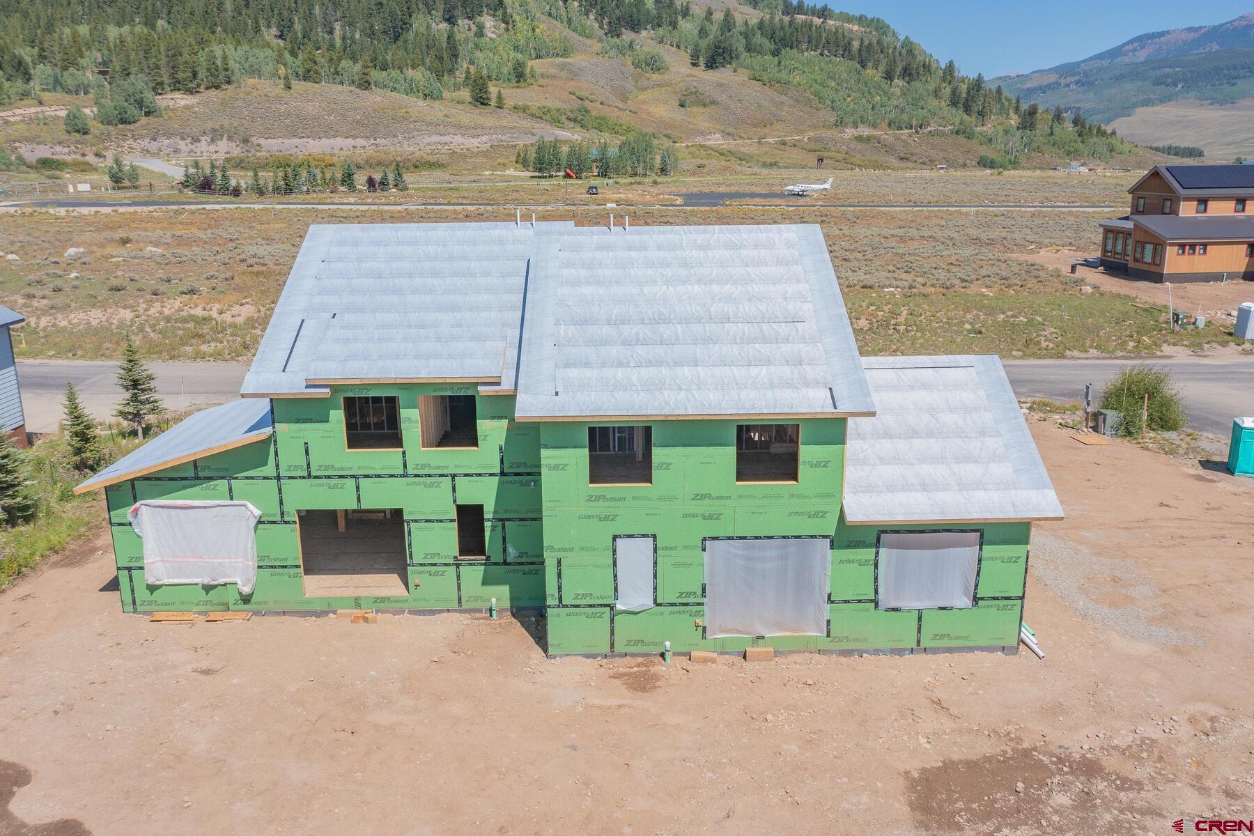 34 Elk Valley Road Crested Butte, CO 81224 - Photo 4 of 24 an aerial view of a house with a yard and lake view