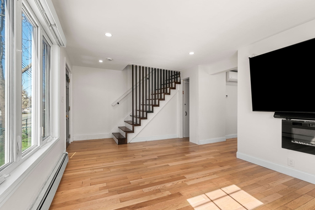 271 Broadway Haverhill, MA 01832 - Photo 6 of 41 a view of a livingroom with wooden floor and stairs