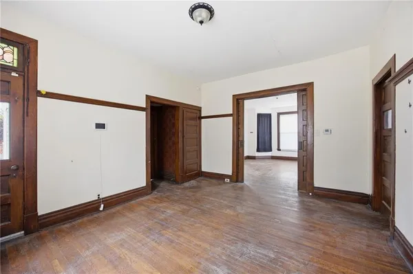 a view of a livingroom with wooden floor and a ceiling fan