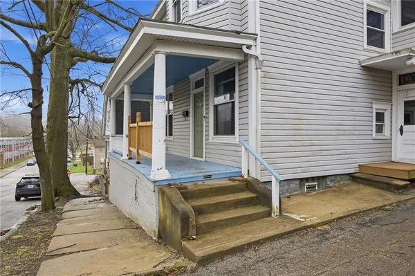 a view of a house with a door and a fire pit