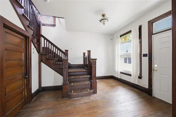 a view of entryway with stairs and wooden floor