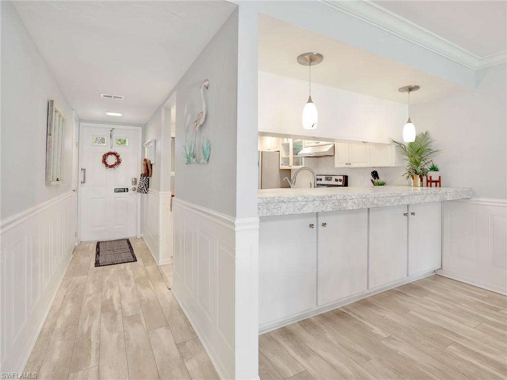4230 Jack Frost Court, Unit 7 Naples, FL 34112 - Photo 11 of 23 a view of a kitchen with a sink and refrigerator