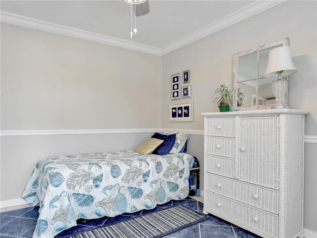 4230 Jack Frost Court, Unit 7 Naples, FL 34112 - Photo 20 of 23 a bedroom with a bed and cabinet