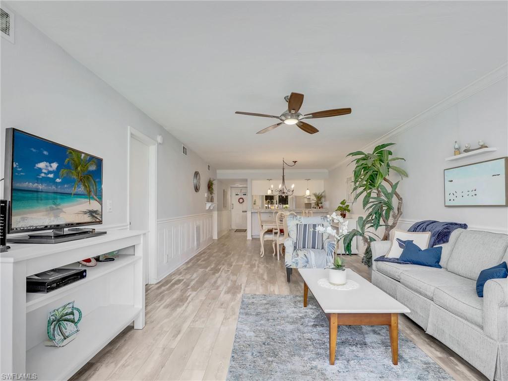 4230 Jack Frost Court, Unit 7 Naples, FL 34112 - Photo 2 of 23 a living room with furniture and a flat screen tv