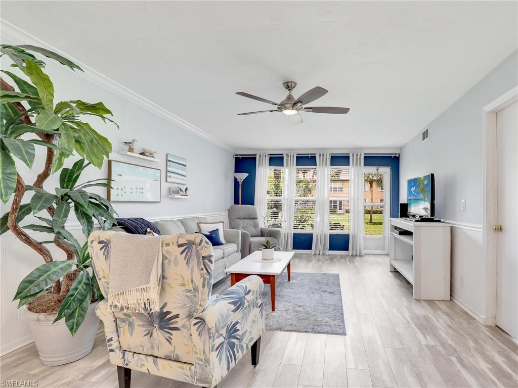4230 Jack Frost Court, Unit 7 Naples, FL 34112 - Photo 3 of 23 a living room with furniture and a large window