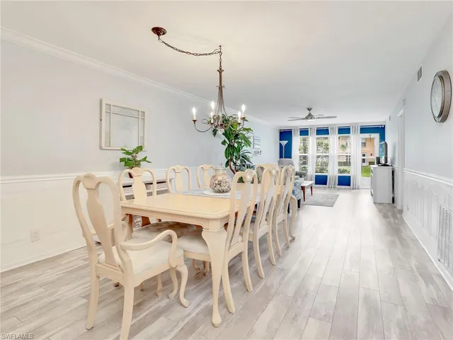 a living room with furniture a large window and a flat screen tv