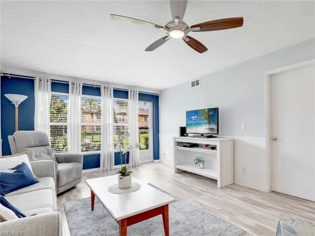 a living room with furniture and a potted plant