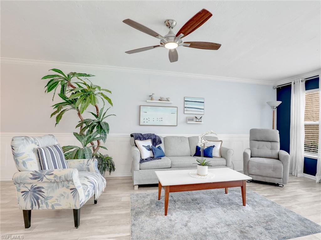 4230 Jack Frost Court, Unit 7 Naples, FL 34112 - Photo 9 of 23 a living room with furniture and a potted plant