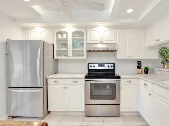 a view of a kitchen with a sink and refrigerator