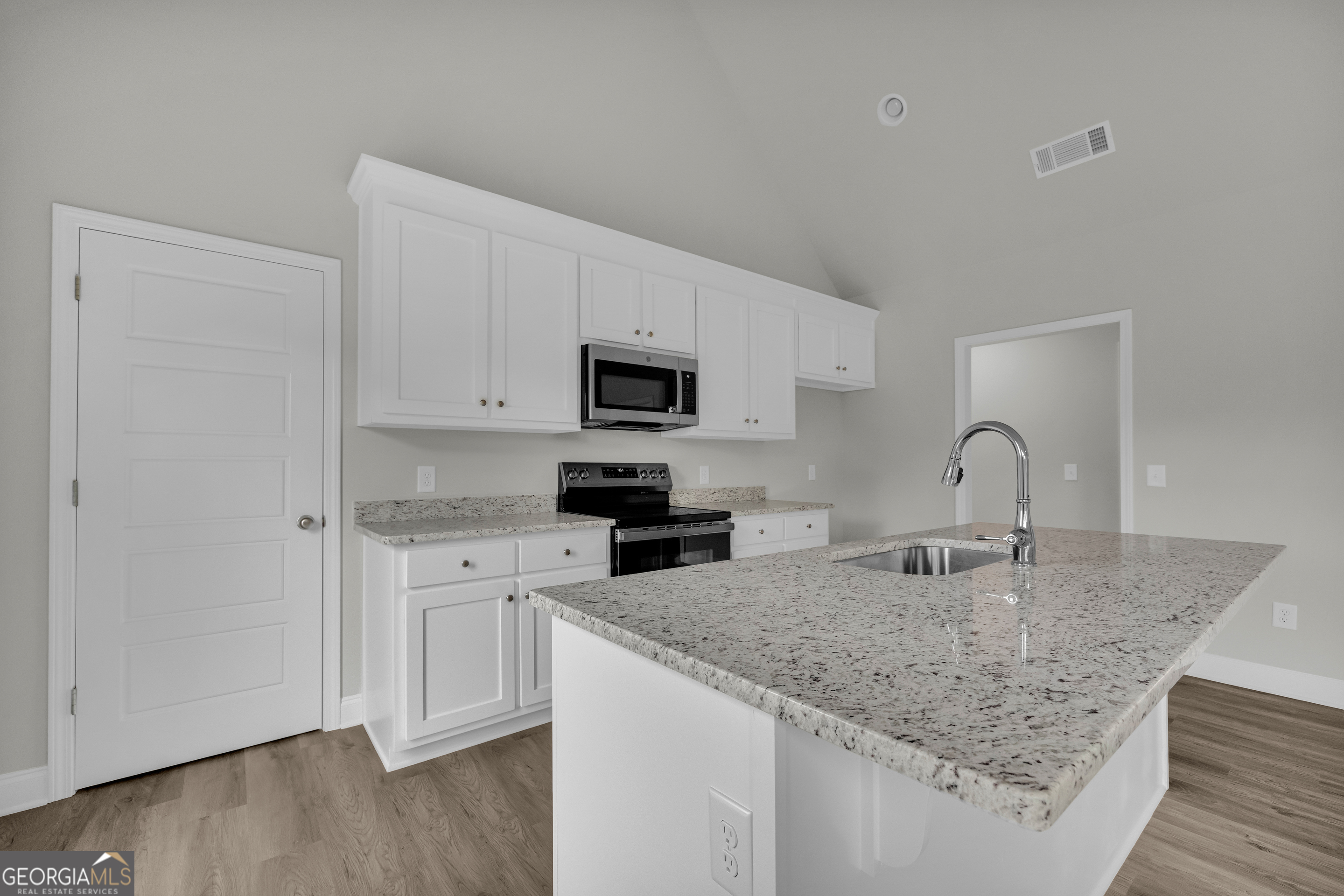 110 Sewell Road Lavonia, GA 30553 - Photo 35 of 73 a kitchen with granite countertop a sink and a stove top oven