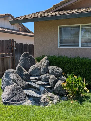 a front view of house with yard and outdoor seating