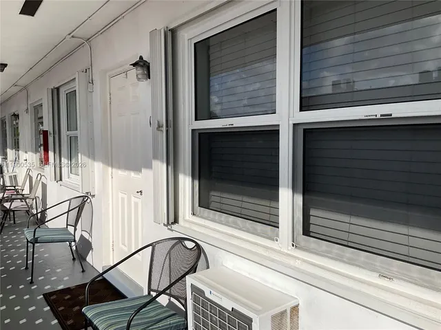 a swimming pool with outdoor seating and yard