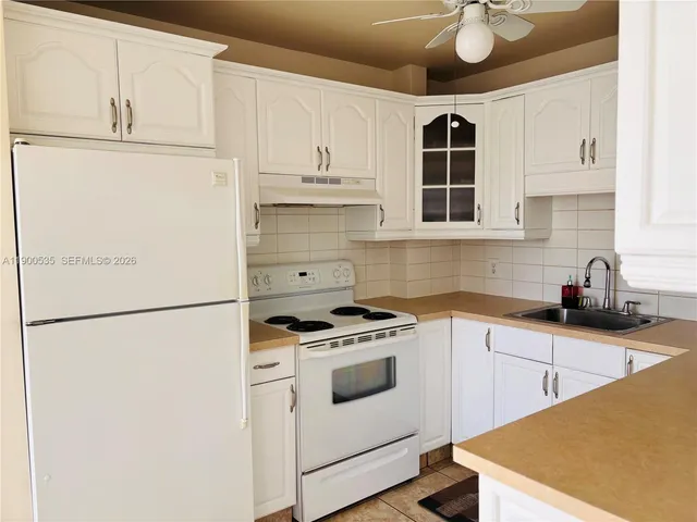 a view of a kitchen with sink washer and dryer