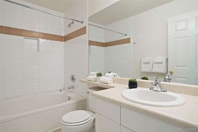 a bathroom with a sink toilet vanity and shower