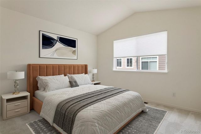 a bedroom with a large bed and a window