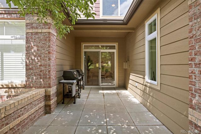 a view of a chairs and a table in the balcony