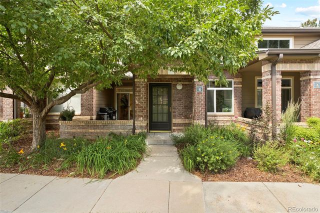 front view of a house with a garden