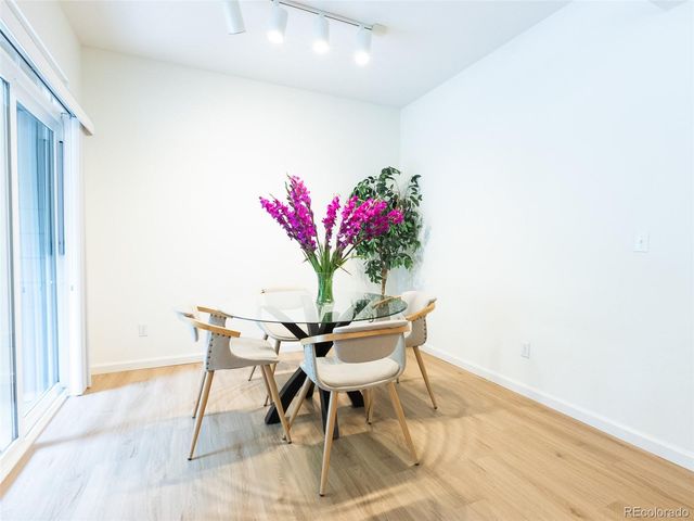 a dining room with furniture and wooden floor