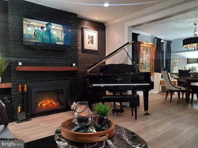 a living room with furniture a fireplace and a flat screen tv