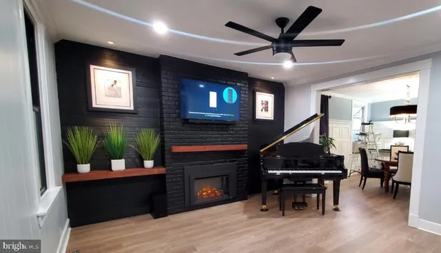 a living room with furniture a fireplace and pool table