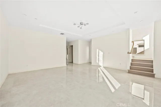 a view of a kitchen with a sink and dishwasher a refrigerator with wooden floor